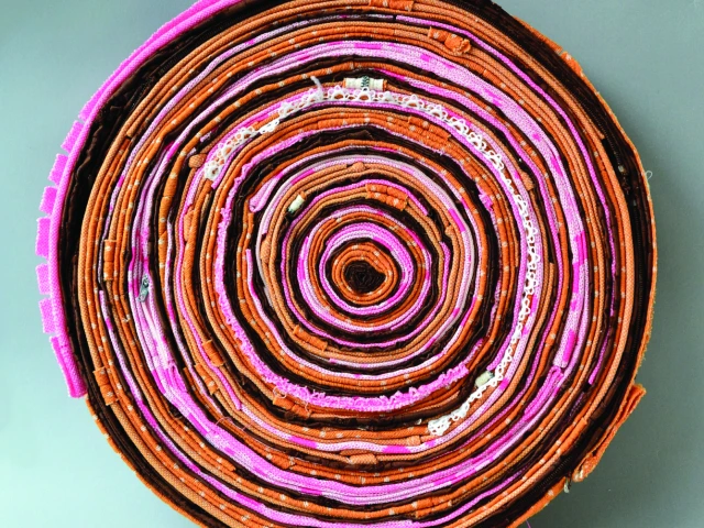 Concentric strips of cloth resembling tree rings.