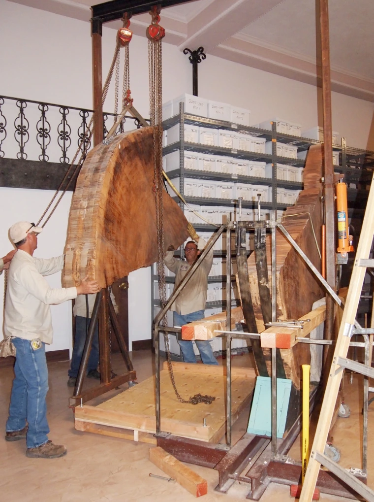 Professional riggers guiding the piece down